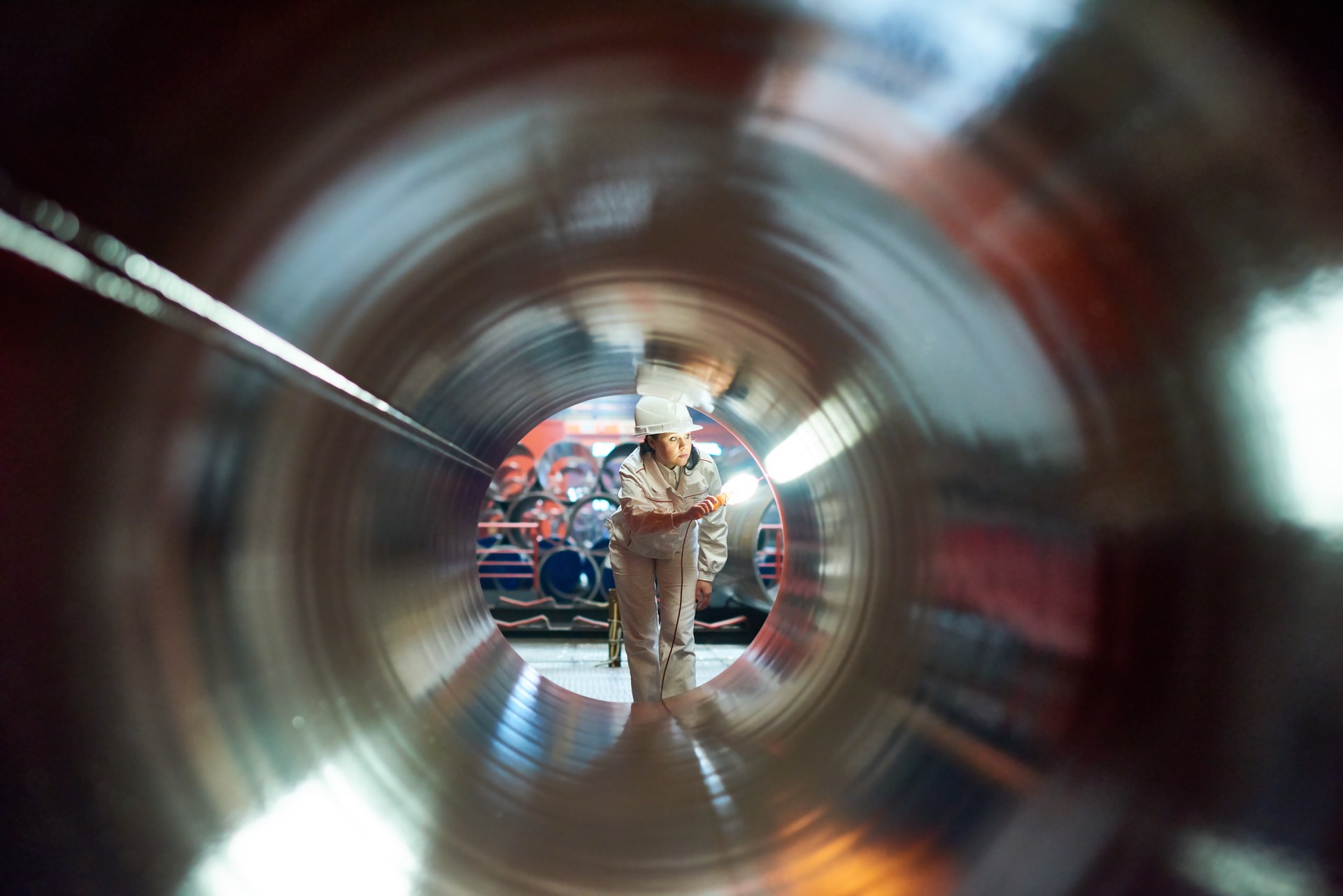 Maintenance engineer examining quality of tube